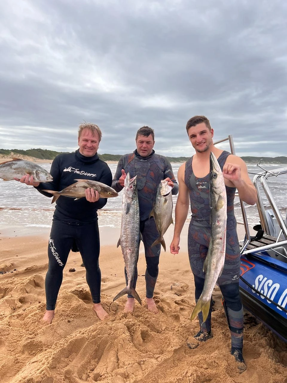 Spearfishers holding caught fish